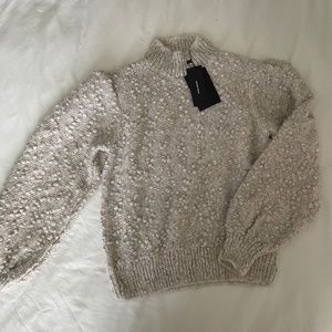 Mockneck puff shoulder sweater.